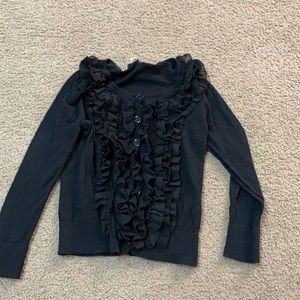Black long sleeve shirt with flared pieces in the front